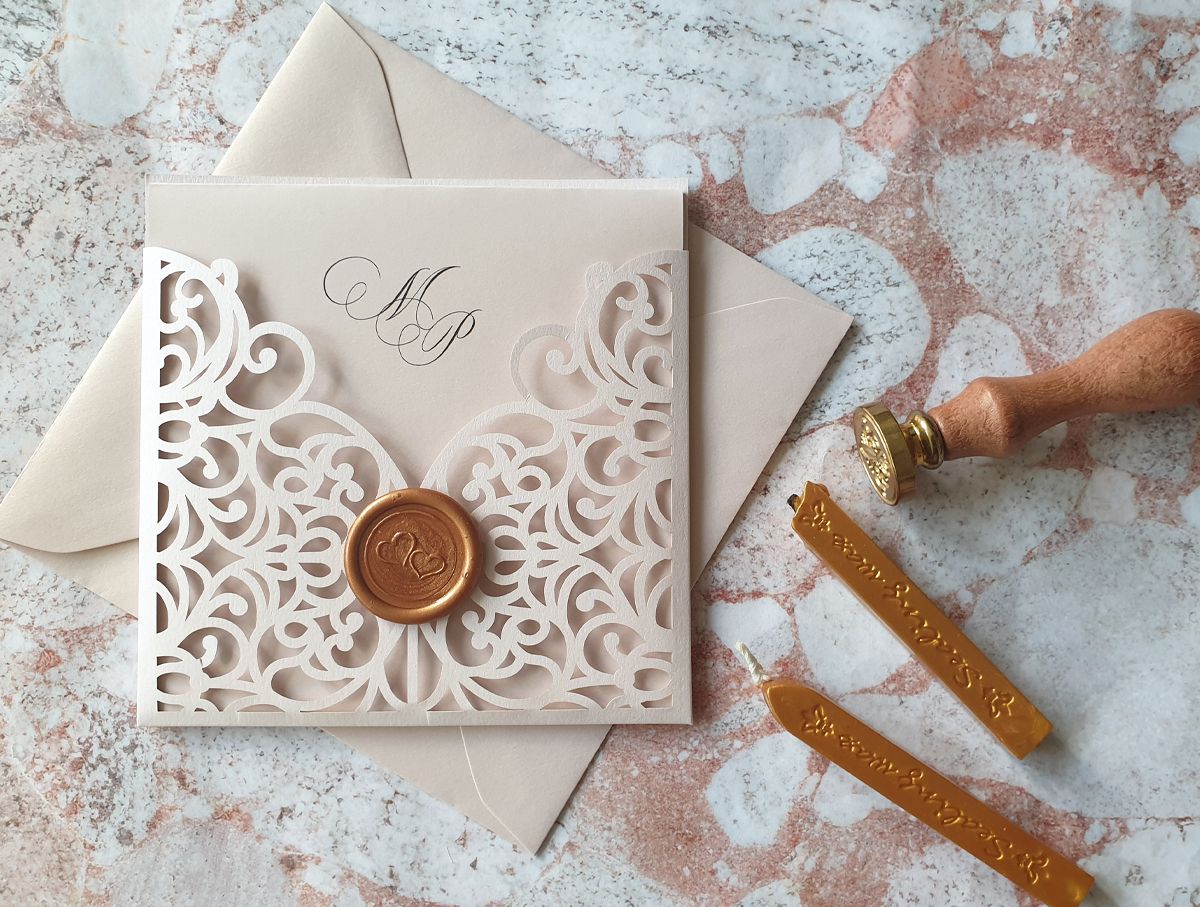blush pink wedding invitation with rose gold wax seal