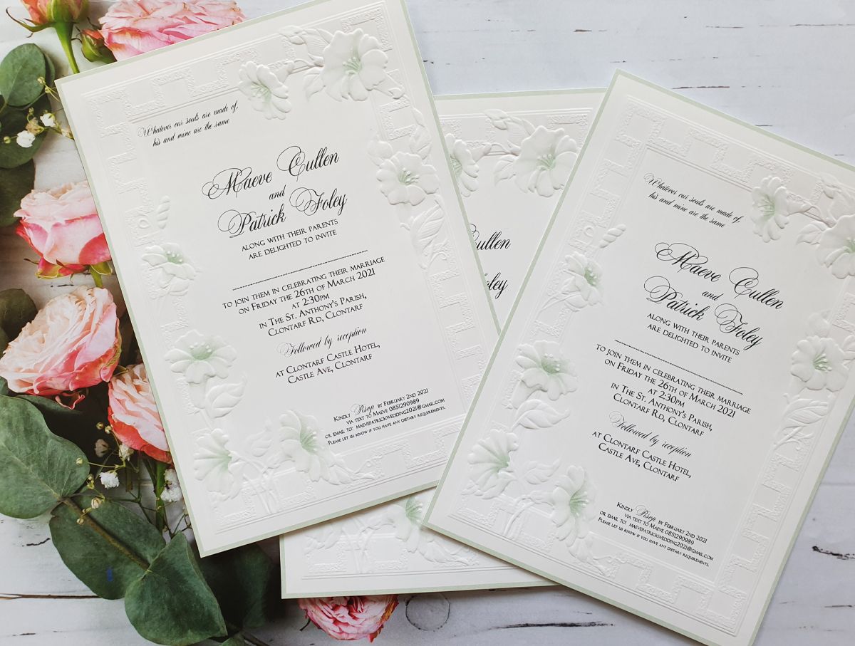 white and green embossed wedding invitation